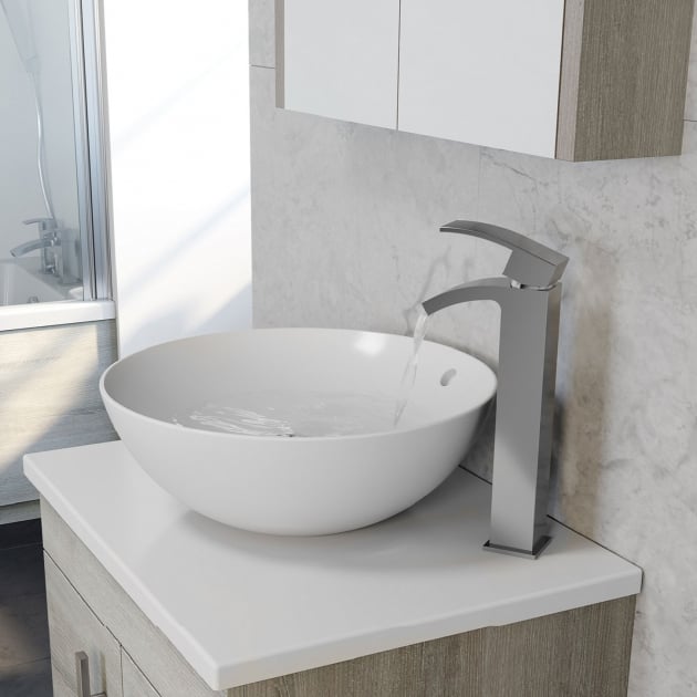 Kartell K-VIT Purity round sit-on bowl on a ceramic worktop with a hi-rise mixer