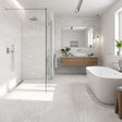 Edgartown white stone effect matt ceramic wall tile 300x600mm in a bathroom setting