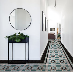 Edisto emerald green Victorian pattern matt porcelain floor tile 338x338mm laid in a hallway
