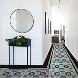 Edisto emerald green Victorian border and corner laid round a patterned hallway floor