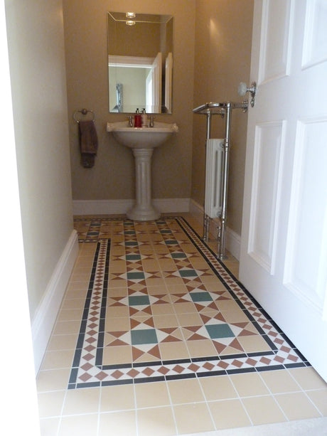 Jekyll yellow Victorian pattern matt porcelain floor tile 285x285mm laid in a room