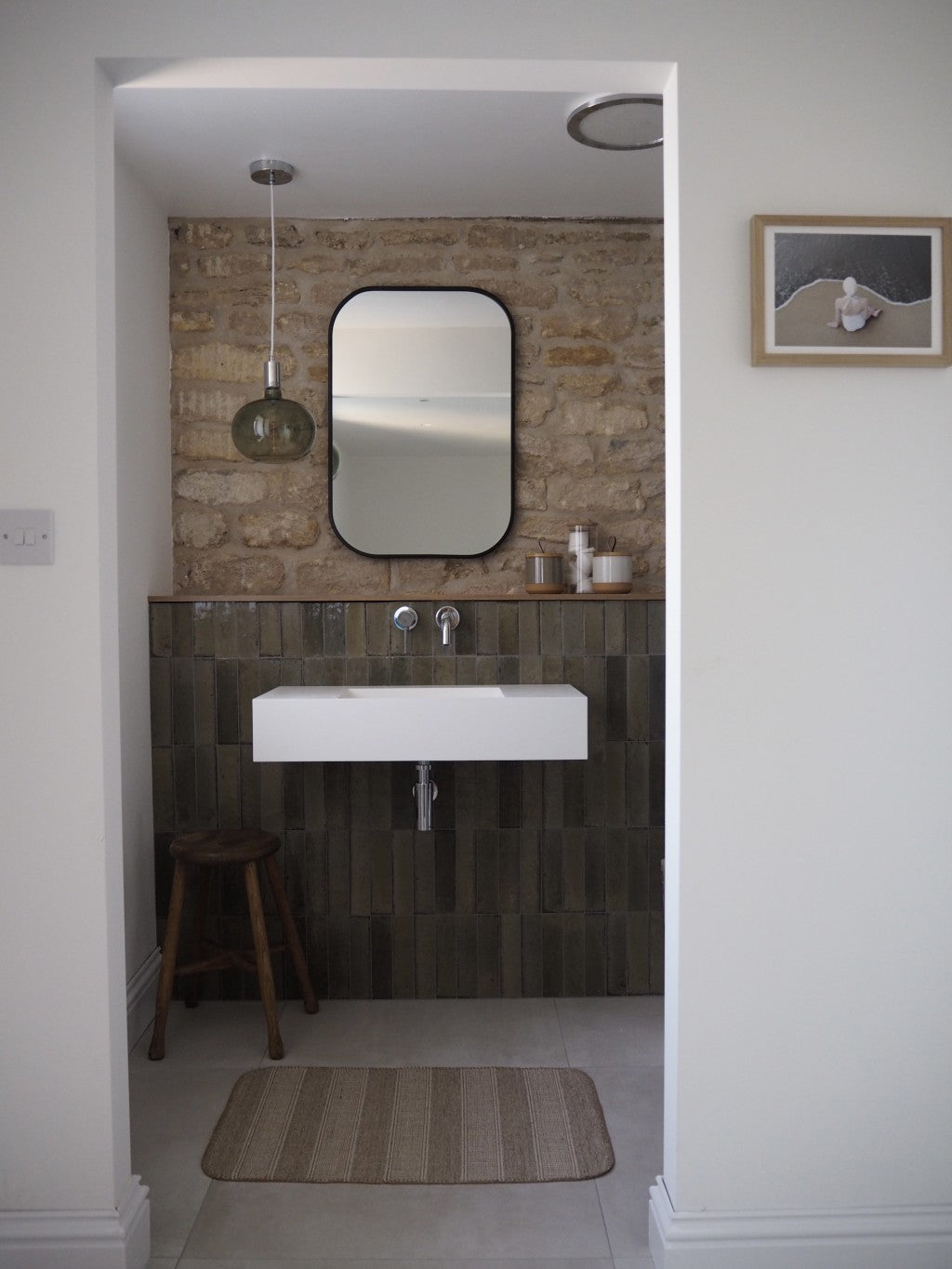 Montauk greige gloss porcelain brick tile 240x60mm on a wall