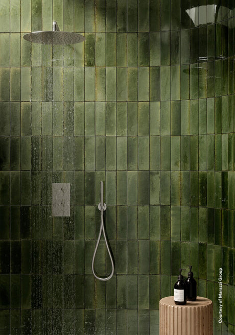 Montauk olive gloss porcelain tile 240x60mm on a wall