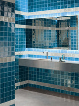 Stonington Petrol Blue gloss ceramic 70x140mm tiles on a wall